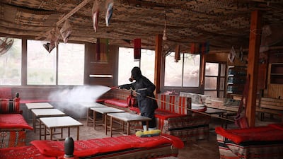 A labourer sprays disinfectant in Jordan's archaeological city of Petra south of the capital Amman. AFP