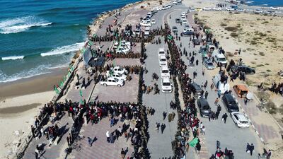 Palestinians and Hamas militants gather for a hostages-detainees swap between Hamas and Israel, in Gaza City, on February 1. Reuters