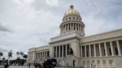 A horse-drawn carriage passes the National Capitol building in Havana, Cuba, where a subtle Arab influence endures. Reuters