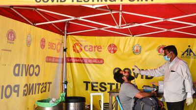 Under tightened Covid-19 rules, a passenger is tested for the coronavirus after arriving at Chennai International Airport, in eastern India. EPA