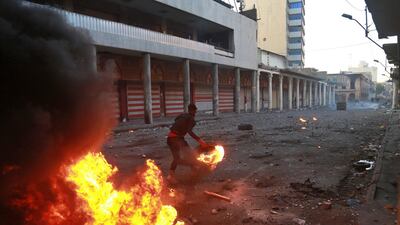 Riot police fire tear gas while protesters set fires during clashes. AP Photo
