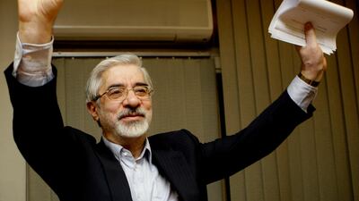 FILE - This Friday, June 12, 2009, file photo, shows Iranian reformist presidential candidate Mir Hossein Mousavi waving to the media during a late night press conference after polls closed in Tehran. A website long associated with detained opposition leader Mir Hossein Mousavi has quoted him as comparing a crackdown on protesters under Iran’s supreme leader to another carried out under the country’s ousted shah. The comments published Saturday, Nov. 30, 2019, represent some of the harshest yet attributed to Mousavi, a 77-year-old politician whose disputed election loss in 2009 led to widespread protests before being put down by security forces. (AP Photo/Kamran Jebreili)
