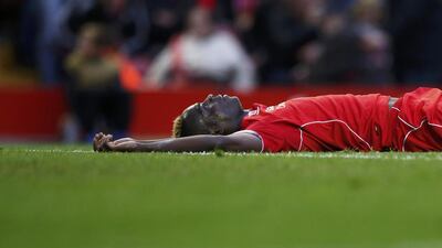 Liverpool's Mario Balotelli lies on the pitch as he reacts after having a penalty claim turned down against Hull City in a 0-0 Premier League draw on Saturday at Anfield. Phil Noble / Reuters / October 25, 2014