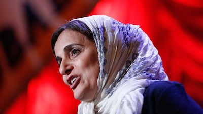 A reader congratulates Sheikha Lubna on her winning the Clinton Global Citizen Award. JP Yim / AFP