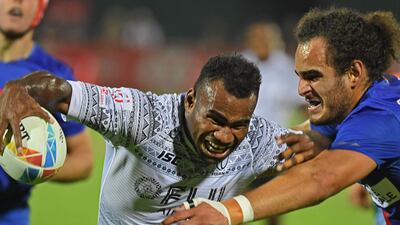 Jonathan Laugel of France (R) vies for the ball with Alasio Naduva (L) of Fiji during the HSBC Dubai Sevens Series men's rugby match between Fiji and France, at the Sevens Stadium in Dubai AFP