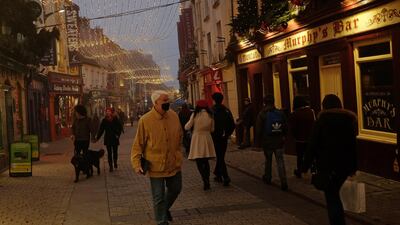 Christmas lights are seen as shoppers walk through the city centre during foggy weather in Galway, Ireland, December 7. Reuters
