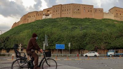 Men ride bicycles in front of the Arbil citadel in the capital of the northern Iraqi Kurdish autonomous region. AFP