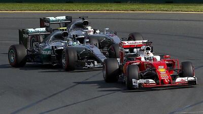 Ferrari F1 driver Sebastian Vettel leads Mercedes F1 drivers Lewis Hamilton and Nico Rosberg during the start of the Australian Grand Prix in Melbourne. REUTERS/Jason Reed