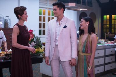 Michelle Yeoh with Henry Golding as her son, Nick, and Constance Wu, who plays his girlfriend, Rachel. Sanja Bucko / Warner Bros. Pictures