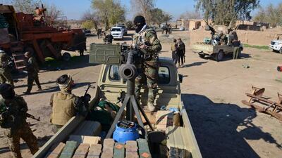 A Shiite fighter (C) mans a heavy machine gun as he takes his position on at the outskirts of Balad, north of Baghdad on December 25, 2014. Iraq's Shiite led government launched a new offensive on Sunday aimed at breaking ISIL’s grip around both Balad and Dhuluiya. Reuters