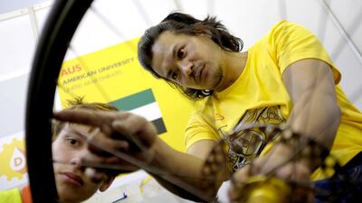 American University of Sharjah team technician Ronald Almires discusses mechanical enhancements Muhammad Attia, the team operations manager. Jes Aznar for The National