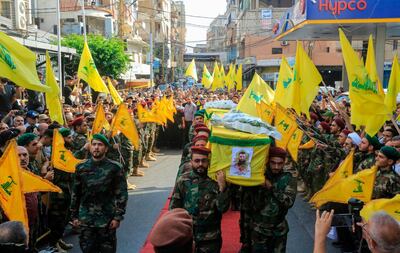 Members of Lebanon's Hezbollah movement carry the coffins of comrades who were killed in Israeli strikes in Syria, in southern Beirut on August 26, 2019. AFP