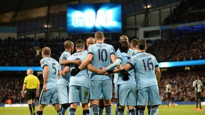 Manchester City's Edin Dzeko celebrates with teammates after scoring his side's third goal on Saturday. Oli Scarff / AFP