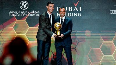 Portuguese football agent Jorge Mendes (R) poses with Juventus' Portuguese forward Cristiano Ronaldo after receiving the Best Agent of the Year Award during the 10th edition of the Dubai Globe Soccer Awards in Dubai. AFP