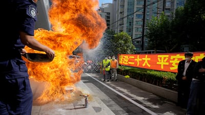 People attend an emergency drill next to a banner welcoming the National Congress of the Communist Party of China, at a residential compound in Shanghai. Reuters