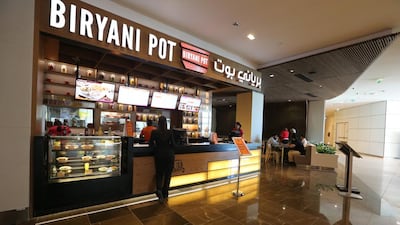 Biryani Pot’s sit-down space is dotted with cream couches and formica furniture. Fatima Al Marzooqi / The National