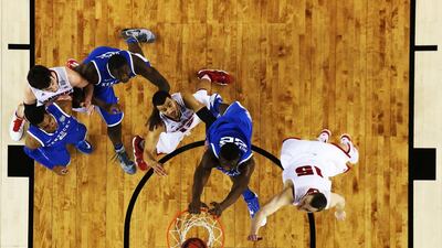 Alex Poythress of Kentucky dunks as Sam Dekker of Wisconsin defends during Saturday’s Final Four game. Jamie Squire / Getty Images / AFP / April 5, 2014