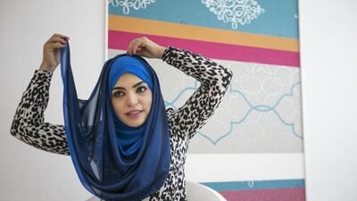 Step 3: Wrap the scarf back in the same direction to reveal the other colour and join the longest end to the top of the head and pin it again.