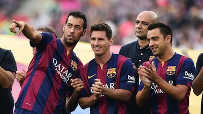 Barcelona midfielder Sergio Busquets (L), Barcelona forward Lionel Messi and Barcelona Xavi stand during an official team presentation before a pre-season friendly on Monday. Josep Lago / AFP / August 18, 2014
