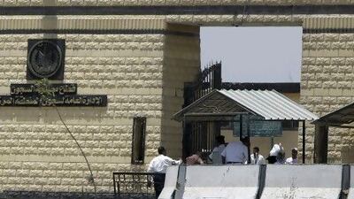 Policemen and people walk in front of the main gate of Tora prison. REUTERS/Amr Abdallah Dalsh / Reuters