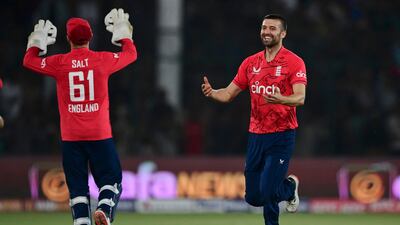 Mark Wood celebrates with teammates after taking the wicket of Pakistan's Haider Ali. AFP