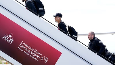 Liverpool's Roberto Firmino and goalkeeper Alisson board the plane before flying out of John Lennon Airport, ahead of the Champions League final in Paris on Saturday. PA