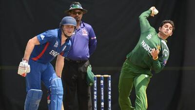 Pakistan bowler Saeed Ajmal sends the ball down as England's Luke Wright looks on.