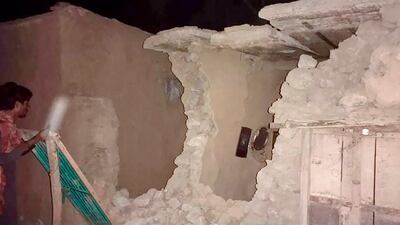 A man inspects his damaged house following a severe earthquake in Harnai, about 100 kilometres from Quetta, Pakistan. AP