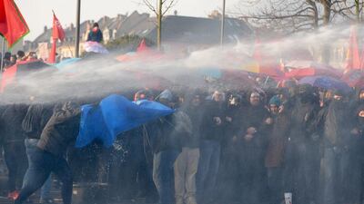 Police deploy a water cannon on a group of protesters. Thousands of riot officers pursued what they said was a minority of violence-minded activists as the bulk of protesters conducted themselves peacefully ahead of a rally in the city’s main square. Boris Roessler / EPA