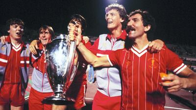 Liverpool players Steve Nicol, Kenny Dalglish, Alan Hansen (obscured), Gary Gillespie, and captain Graeme Souness celebrate with the trophy after beating Roma on penalties in the 1984 final. Getty