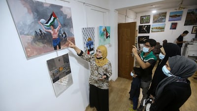 Visitors admire pro-Palestinian artworks at an art studio in Basra. Reuters