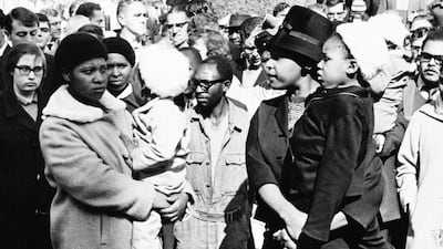 June 12, 1964: Winnie Mandela, right, waits in vain for a glimpse of her husband, Nelson Mandela, outside the Palace of Justice in Pretoria. AP Photo