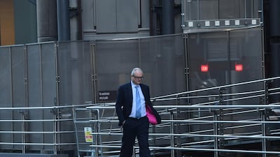 A city worker walks past the Lloyds building in the City of London, Britain. UK finance minister Rishi Sunak extended the country's coronavirus furlough scheme until the end of March last week to help cushion the blow of a second lockdown. EPA