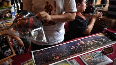 This picture shows vendors selling memorabilia, illustrating the rescue of the 12 boys from the "Wild Boars" football team and their coach. AFP