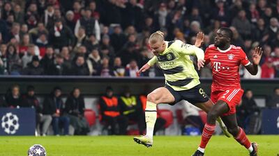 Bayern Munich's Dayot Upamecano brings down Manchester City's Erling Haaland before being shown a red card that was later overruled by VAR. PA
