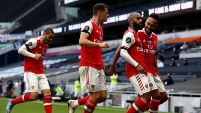 Alexandre Lacazette celebrates the opening goal with teammates. PA