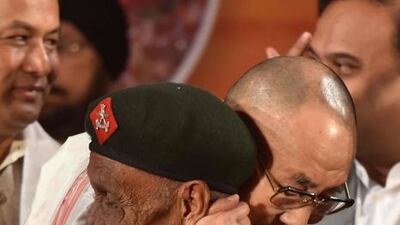 Tibetan spiritual leader the Dalai Lama hugs retired Assam Rifles personnel Naren Chandra Das the lone known survivor of a group of seven Indian soldiers who were the first to receive the Dalai Lama on Indian soil after he fled Tibet. AFP / Biju BORO