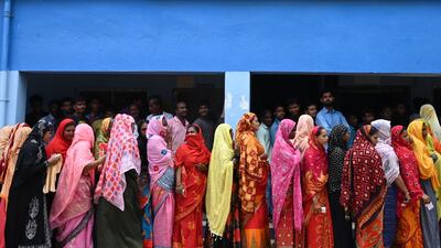 Voters gather at a polling station in Kolkata. Seven people were reported to have been killed and dozens were injured after clashes over local polls across West Bengal