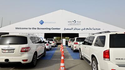 Cars line up as people wait to enter the drive-through testing centre.