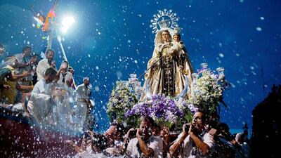 Carriers of the Great God Power brotherhood unload Virgen del Carmen statue after its journey on July 15, 2014 at Puerto de la Cruz dock on the Canary island of Tenerife, Spain. Since 1921, the statue of the Virgen del Carmen, patron saint of fishermen, has been carried with great fanfare annually as part of July Festivities to the Puerto de la Cruz dock where, at the end of its procession, it is hoisted aboard a decorated boat. Weather permitting, the boat carrying the statue, accompanied by a flotilla of other boats, makes a short journey along the island coast before returning to the harbour. In recent years, attendance at the event has numbered more than 35,000 people. Gonzalo Arroyo Moreno / Getty Images