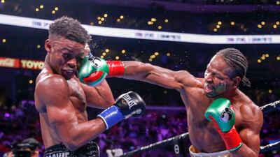 Shawn Porter, right, lands a punch to the face of Errol Spence Jr during the WBC and IBF welterweight title fight in Los Angeles on Saturday, September 28. Spence Jr won the bout via a split decision. AP