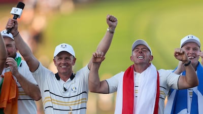 Team Europe captain Luke Donald, left, Rory McIlroy and Robert MacIntyre celebrate at the trophy ceremony after Team Europe defeated Team United States 15-13. AFP