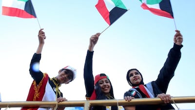 Young women in Kuwait City join in celebrations for the country’s 56th Independence Day. Yasser Al Zayyat / AFP