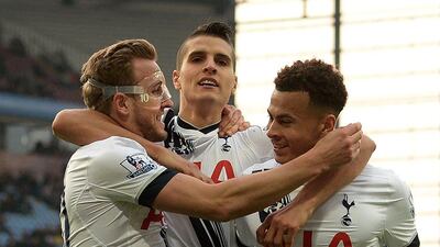 Tottenham Hotspur’s English striker Harry Kane (L) celebrates scoring his team’s second goal with Tottenham Hotspur’s Argentinian midfielder Erik Lamela (C) and Tottenham Hotspur’s English midfielder Dele Alli during the Premier League match between Aston Villa and Tottenham Hotspur at Villa Park in Birmingham, central England on March 13, 2016. AFP / OLI SCARFF