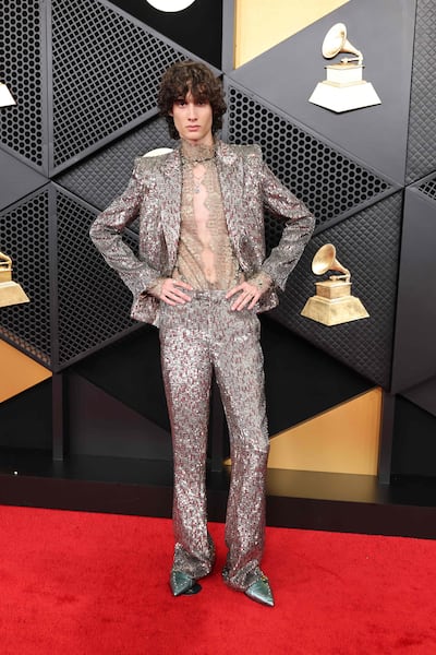 Sombr makes a breakout fashion statement, arriving in a shimmering custom Valentino silver suit layered over a lace shirt. Getty Images
