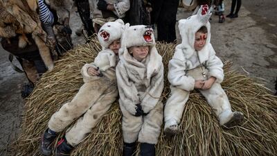 Children dressed in bear costumes celebrate the Malanka festival that celebrates the Julian calendar new year, in the village of Krasnoilsk, Ukraine. AP