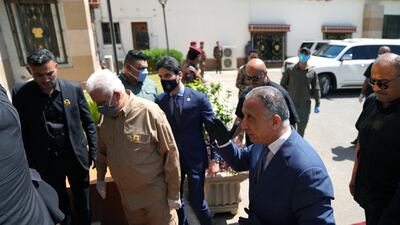 Iraqi Prime Minister Mustafa al-Kadhimi walks with Head of the Popular Mobilization forces Faleh al-Fayyad during meeting in Baghdad, Iraq May 16, 2020. Iraqi Prime Minister Media Office/Handout via REUTERS ATTENTION EDITORS - THIS IMAGE WAS PROVIDED BY A THIRD PARTY.