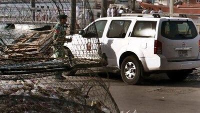 Emirati police and other officials inspect a fishing boat that was shot at by the crew of a United States navy vessel. One fisherman was killed and three other men critically injured.