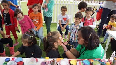 A group of youngsters eagerly await getting their faces painted, which was just one of the many activities during a fun-filled opening weekend at Mushrif Central Park. Delores Johnson / The National