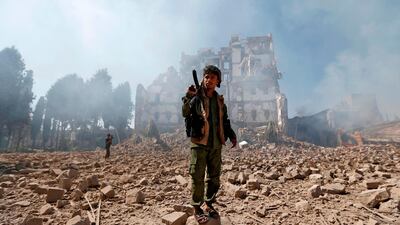Houthi rebel fighters inspect the damage after a reported air strike. AFP